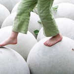 child walking on large spheres