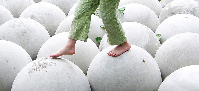 child walking on large spheres
