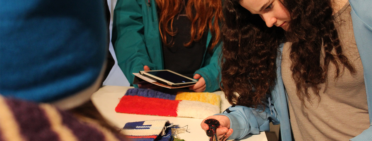 Cove Park Saturday Arts Club by Dovecot Studios, a group of young people handling colourful knitted items